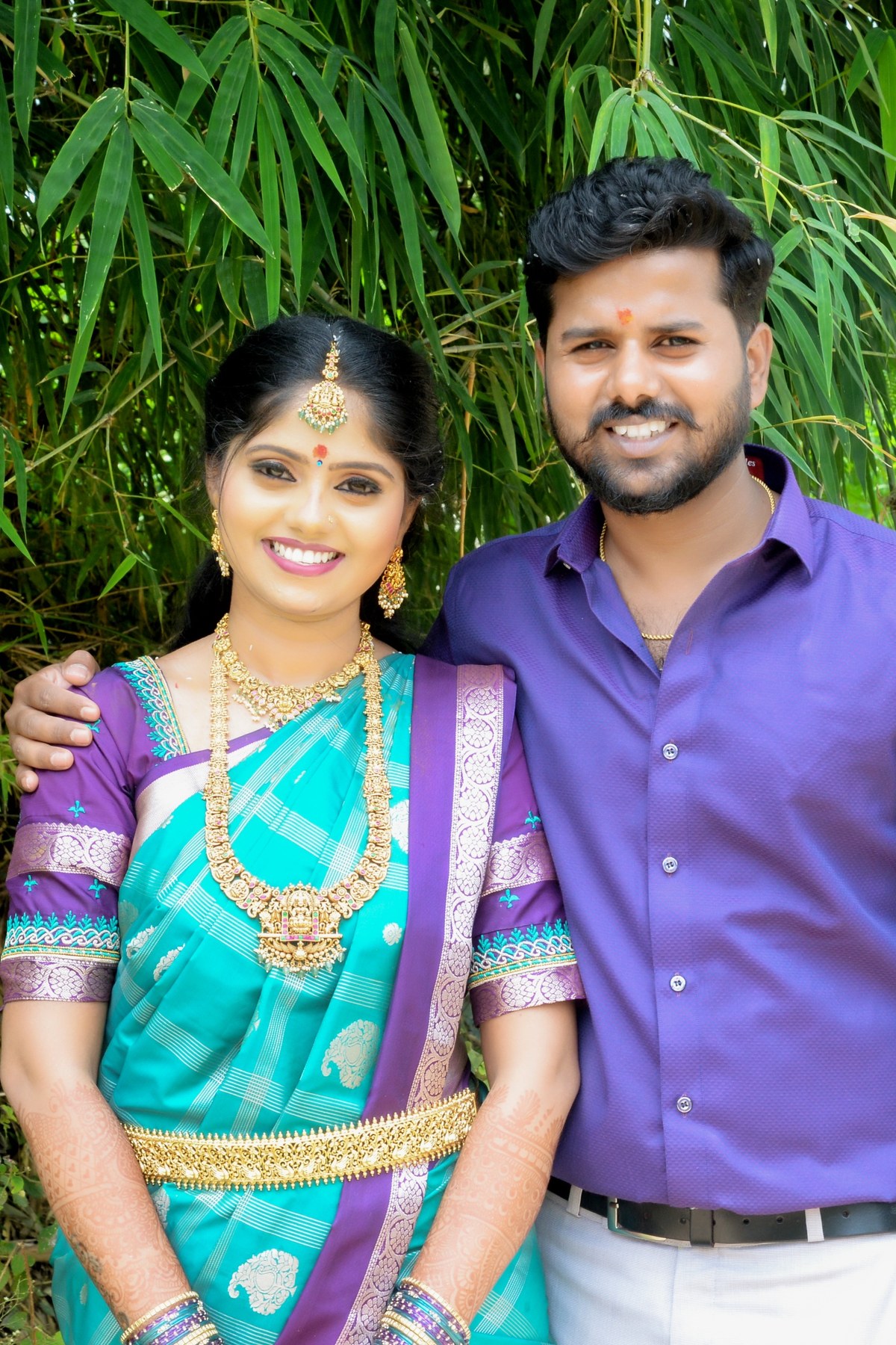 Naveen and Pavana together beneath green bamboo